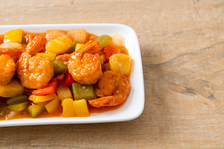 Stir-fried sweet and sour with fried shrimp on plate - Asian food styleの写真素材