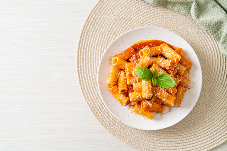 Rigatoni pasta with tomato sauce and cheese - traditional Italian pastaの写真素材