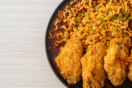 Korean instant noodles with fried chicken or Fried chicken ramyeon - Korean food styleの写真素材