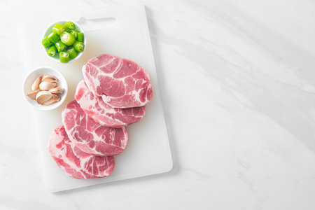 fresh pork neck raw or collar pork on board with ingredients for marinatedの写真素材