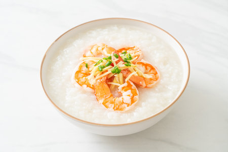 Congee with shrimps and fresh ginger on topの写真素材