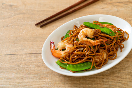 stir-fried yakisoba noodles with green peas and shrimps - Asian food styleの写真素材