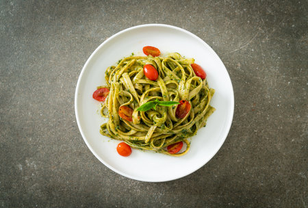 fettuccine spaghetti pasta with pesto sauce and tomatoes - vegan and vegetarian food styleの写真素材