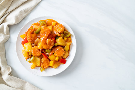 Stir-fried sweet and sour with fried shrimp on plate - Asian food styleの写真素材