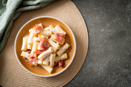 homemade spaghetti rigatoni pasta with white sauce and bacon - Italian food styleの写真素材