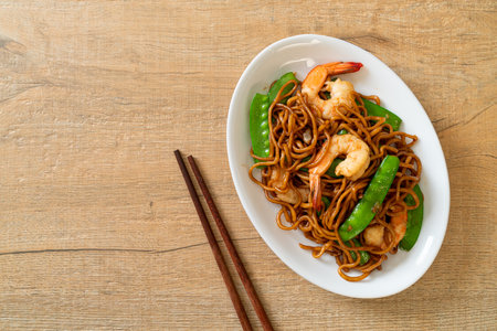 stir-fried yakisoba noodles with green peas and shrimps - Asian food styleの写真素材