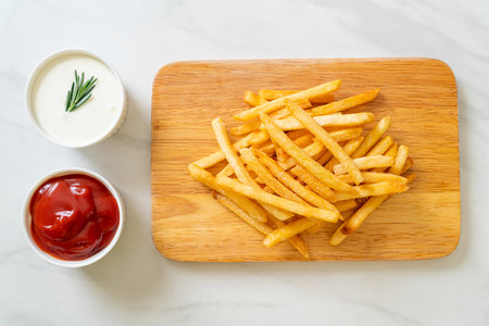 French fries or potato chips with sour cream and ketchupの写真素材