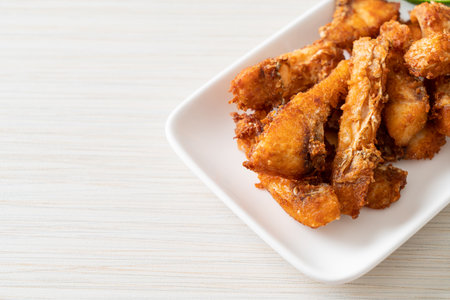 Fried Snapper Belly on white plate - Asian food styleの写真素材