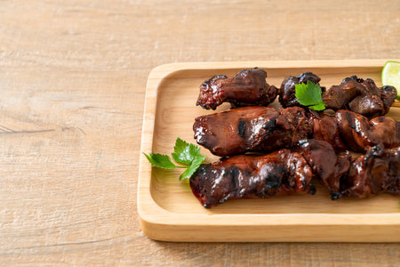 grilled chicken liver with herbs and spices on plateの写真素材