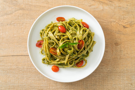 fettuccine spaghetti pasta with pesto sauce and tomatoes - vegan and vegetarian food styleの写真素材