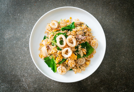 Fried rice with squid or octopus - stir-fried rice with squid, egg and kaleの写真素材