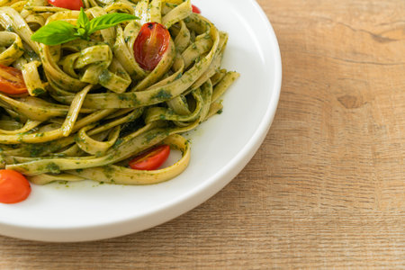 fettuccine spaghetti pasta with pesto sauce and tomatoes - vegan and vegetarian food styleの写真素材