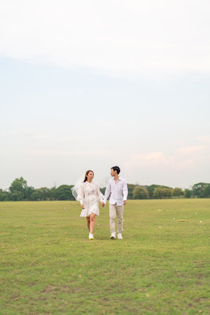 Happy young Asian couple in bride and groom clothing ready for marry and wedding celebrateの写真素材