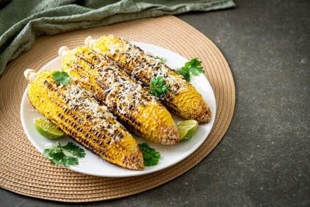 barbecue and grilled corn with cheese and lime on plateの写真素材