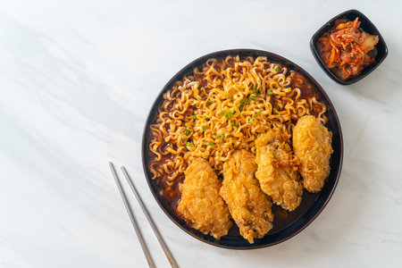Korean instant noodles with fried chicken or Fried chicken ramyeon - Korean food styleの写真素材