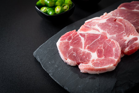 fresh pork neck raw or collar pork on board with ingredients for marinatedの写真素材