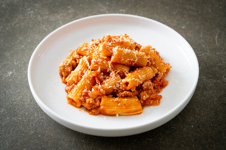 Bolognese rigatoni pasta with cheese - traditional Italian pastaの写真素材