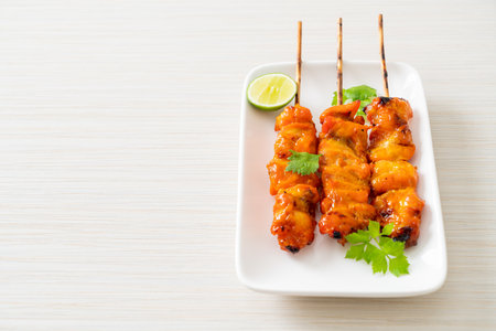 grilled chicken skewer with herbs and spices on plateの写真素材