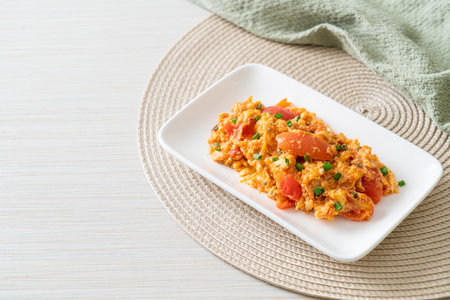Stir-fried tomatoes with egg or Scrambled eggs with tomatoes - healthy food styleの写真素材