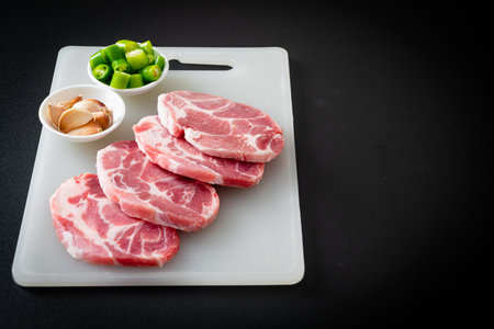 fresh pork neck raw or collar pork on board with ingredients for marinatedの写真素材