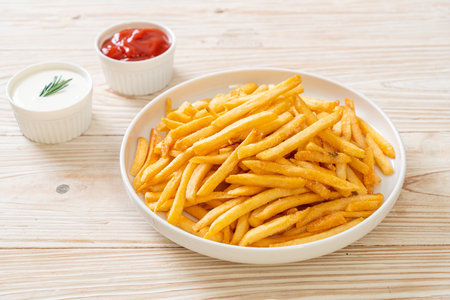 French fries or potato chips with sour cream and ketchupの写真素材