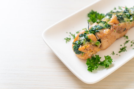 Chicken breasts stuffed with spinach and cheese on plateの写真素材