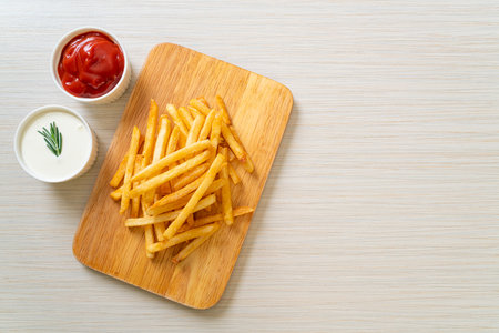 French fries or potato chips with sour cream and ketchupの写真素材