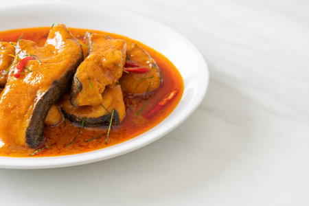 Redtail Catfish Fish in Dried Red Curry Sauce that called Choo Chee or a king of curry cooked with fish served with a spicy sauceの写真素材
