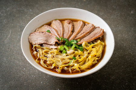 egg noodles with stewed duck in brown soup - Asian food style