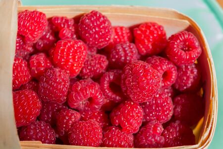 Fresh red raspberry in basket, close upの写真素材