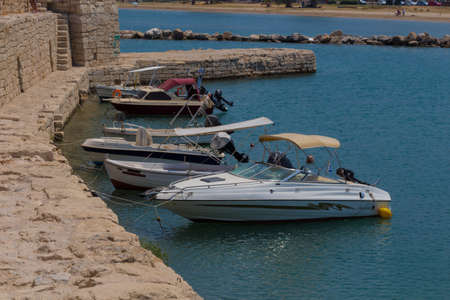 Rethymno, Greece - July  30, 2016: Boats in the Venetian harbour. The Venetian Harbor of Rethymnon, next to the modern harbor of the city, with the Egyptian lighthouse is one of the most picturesque areas of the old town. It operated in the Byzantine periのeditorial素材
