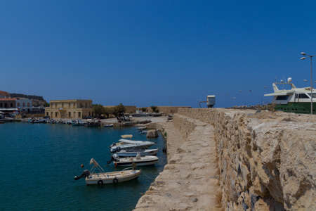 Rethymno, Greece - July  30, 2016: Boats in the Venetian harbour. The Venetian Harbor of Rethymnon, next to the modern harbor of the city, with the Egyptian lighthouse is one of the most picturesque areas of the old town. It operated in the Byzantine periのeditorial素材