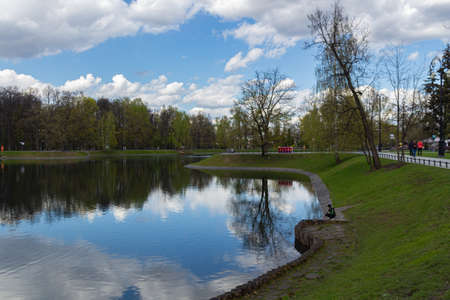 MOSCOW, RUSSIA - May 07, 2021: Beautiful Ostankino Park in Moscow, spring pond with reflection in...
