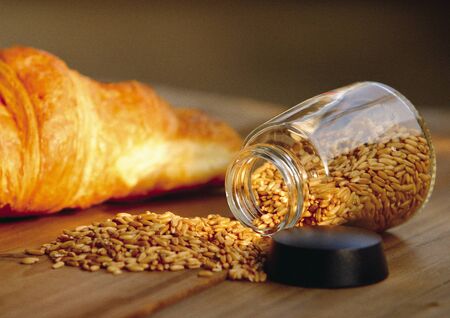 Close-up of wheat grain near a croissantの写真素材