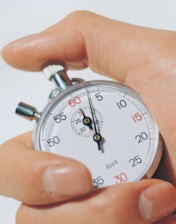 Close-up of a stopwatch in a man's handの写真素材