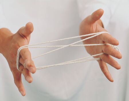 Close-up of string on a man's handsの写真素材