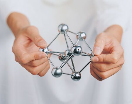Close-up of a metal helix in a man's hands