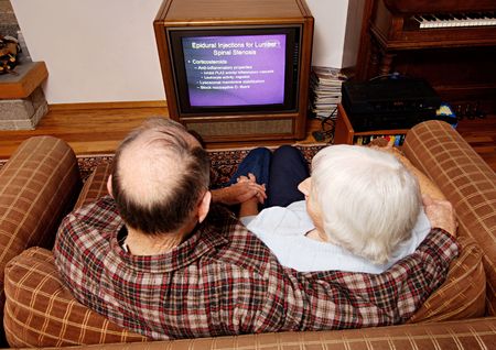 High angle view of an elderly couple watching televisionの写真素材