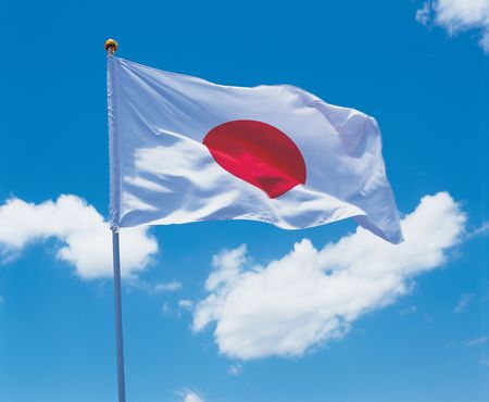 Low angle view of the Japanese flag on a poleの写真素材