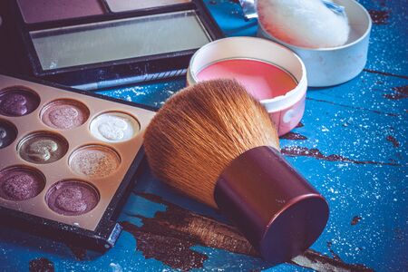 makeup brushes and eyeshadows on blue backgroundの写真素材