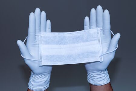 Doctors and nurses Wear gloves and a mask To prevent viruses that float in the air and come into contact with various things. Concept: Avoid direct contact with various items and prevent the virus from entering the body.の写真素材