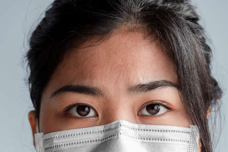 Asian woman Wearing a face mask Prevent germs and prevent the coronavirus, Concept of protection against germs and viruses.の写真素材