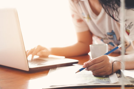 Business woman making notes at home workplace . Business job offer, financial success, certified public accountant concept, work from home concept.の写真素材