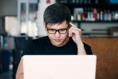 Young business man is planning business events and planning finances and investments, Use a laptop for work.の写真素材