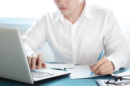 Asian men working at their desks with notebooks taking notes Accepting orders from online customers, online business and e-commerce, Online stores selling products.の写真素材