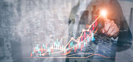 Businessman draws graphs of business growth and analyzes financial and investment data, planning business, finance and investment strategies on Business finance background.の写真素材