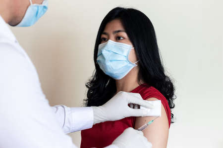 Doctors are vaccinating against COVID to Asian women, Approximately 24-30 years To prevent COVID-19 infection.の写真素材