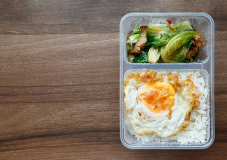 Kale Fried Rice with Crispy Pork Belly In a clear plastic box It is the most popular food in Thailand.の写真素材