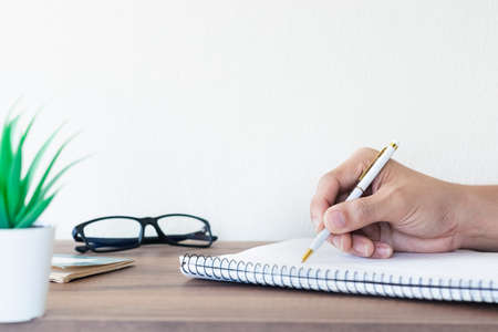 Asian men working at their desks with notebooks taking notes Accepting orders from online customers, online business and e-commerce, Online stores selling products.の写真素材