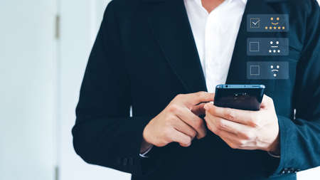 Businessmen User give rating to service experience on online application, Customer review satisfaction feedback survey concept,  Customer can evaluate quality of service leading to reputation ranking of business.の写真素材